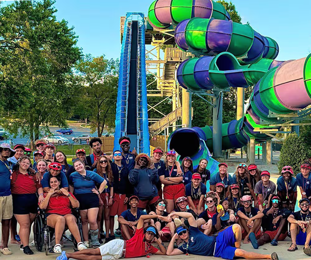 Team member photo of group of employees by water slide