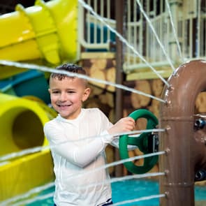 Young boy splashing in the water