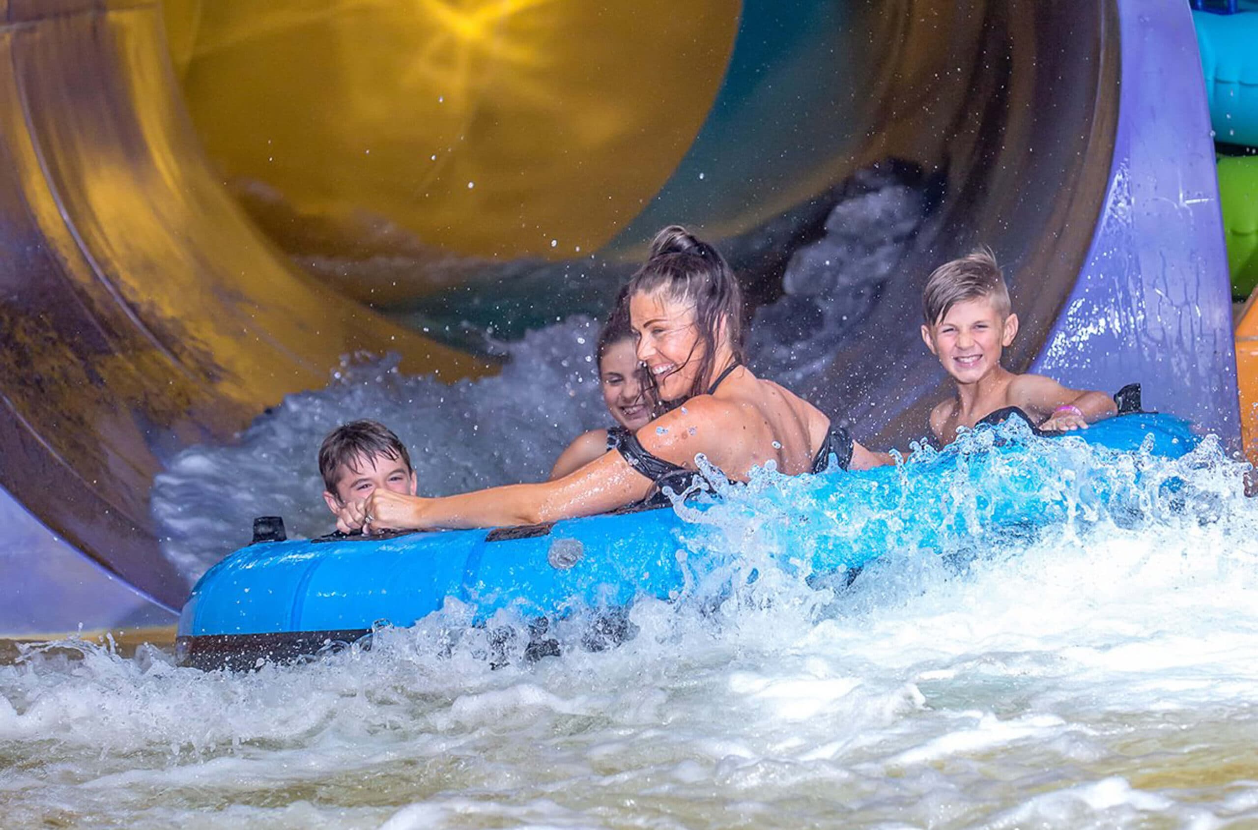 family riding on waterslide