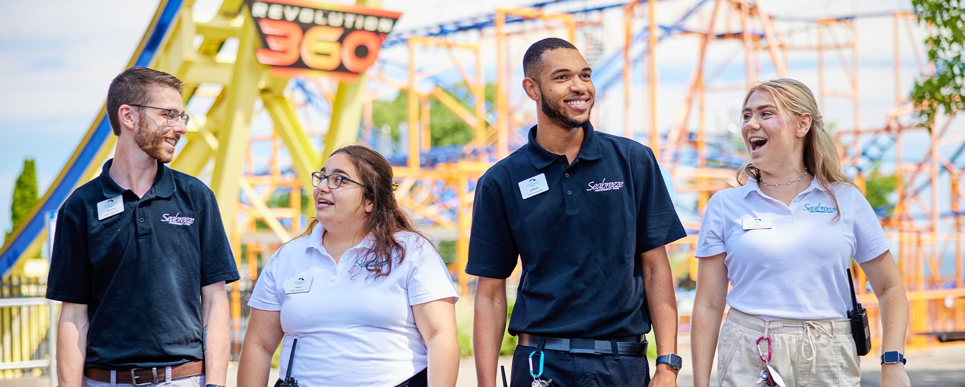 Seabreeze employees walking excitedly in front of rides