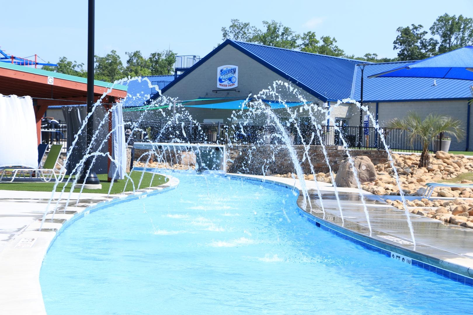 Spivey Splash water park building with water shooting over the Lazy River